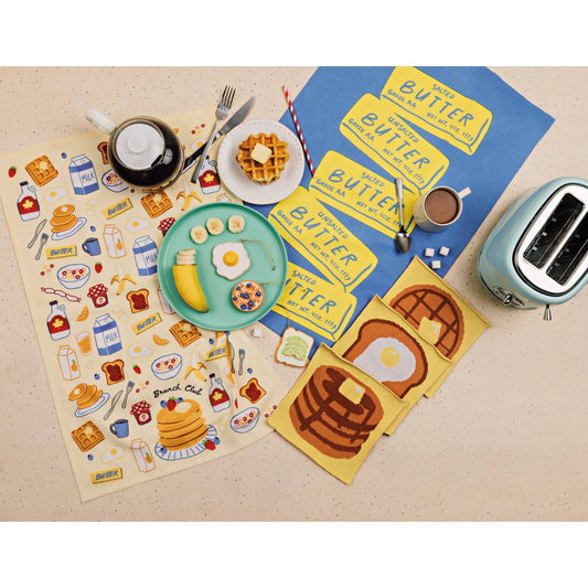 Breakfast-themed kitchen cloth set with a toaster on a beige surface
