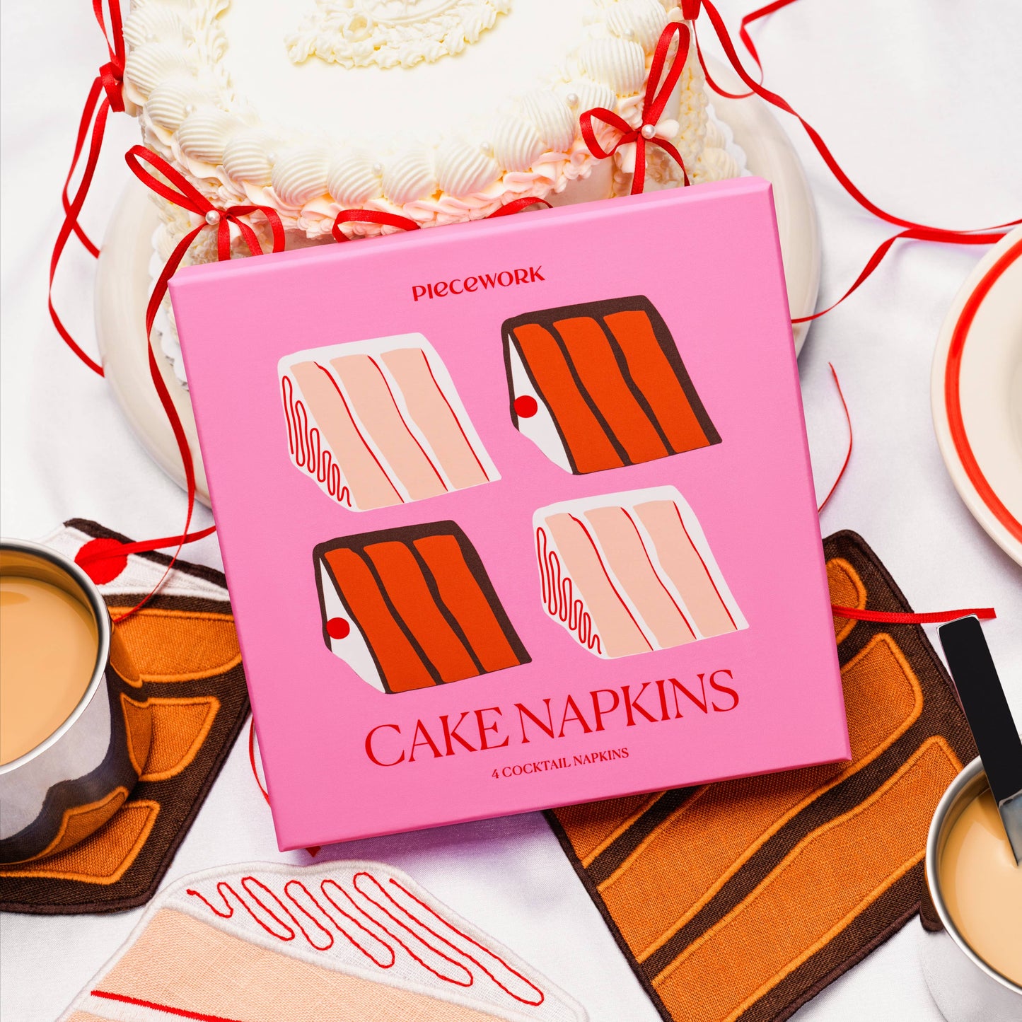 Pink box of cake napkins with illustrations on a white background