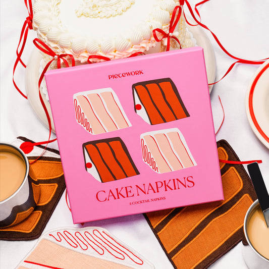 Pink box of cake napkins with illustrations on a white background