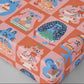 Patterned gift wrap sheet with cartoon cats and desserts on a pink and orange background
