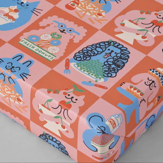 Patterned gift wrap sheet with cartoon cats and desserts on a pink and orange background