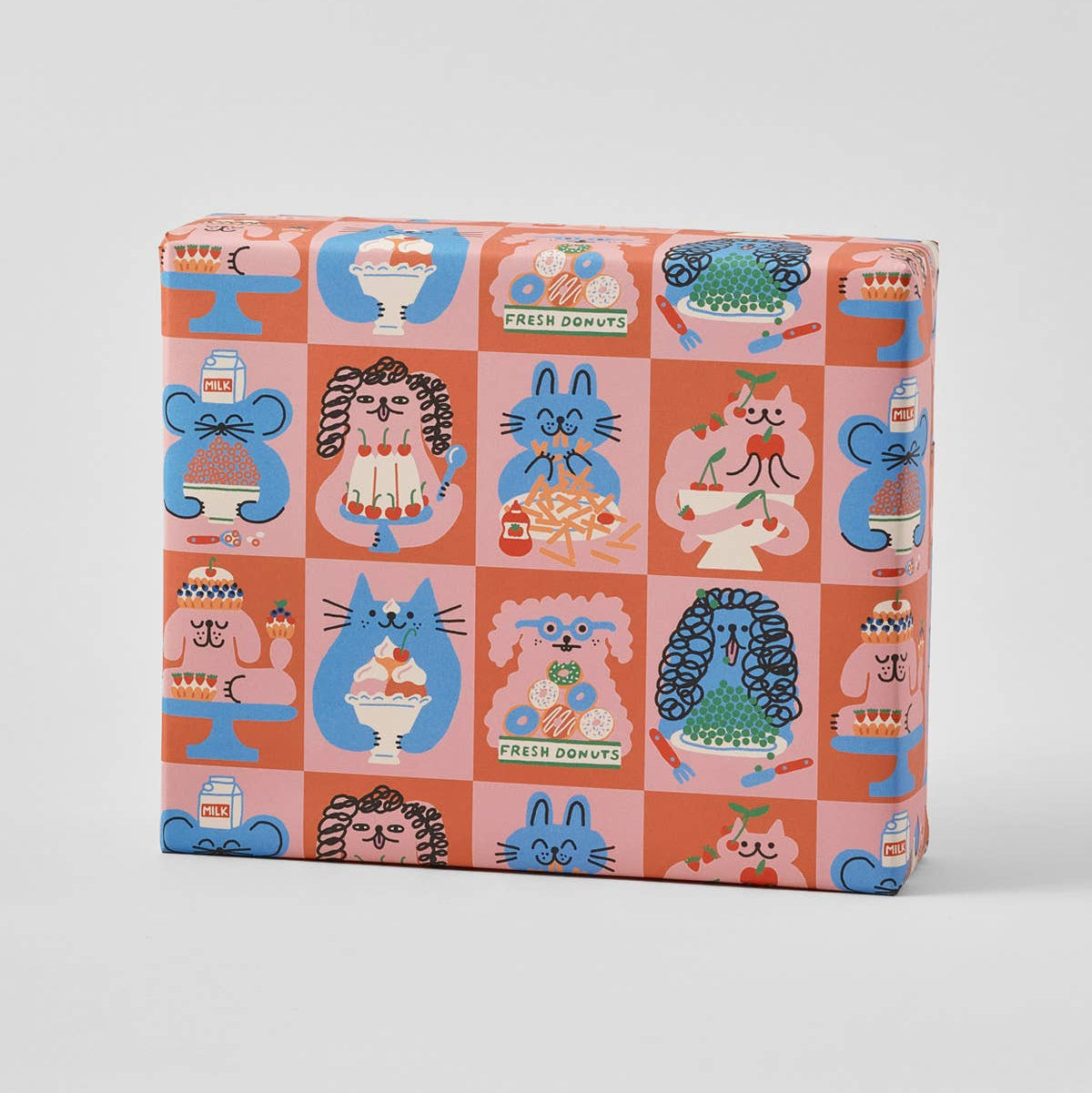 Packaging with a colorful pattern of cartoon animals and objects on a white background