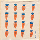 Beige towel with cartoon carrot pattern on a wooden surface