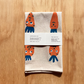 Towel with cartoon carrots design on a wooden surface