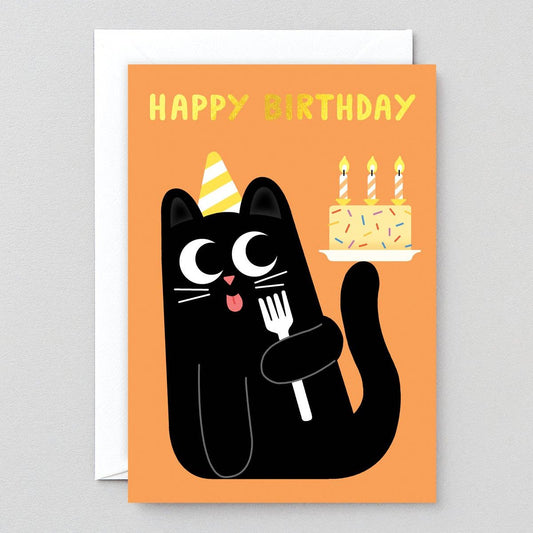 Card with "Happy Birthday" in gold foil and illustration of a black kitty wearing a yellow striped party hat while licking a fork and balancing a birthday cake (with sprinkles and three candles) on its tail.