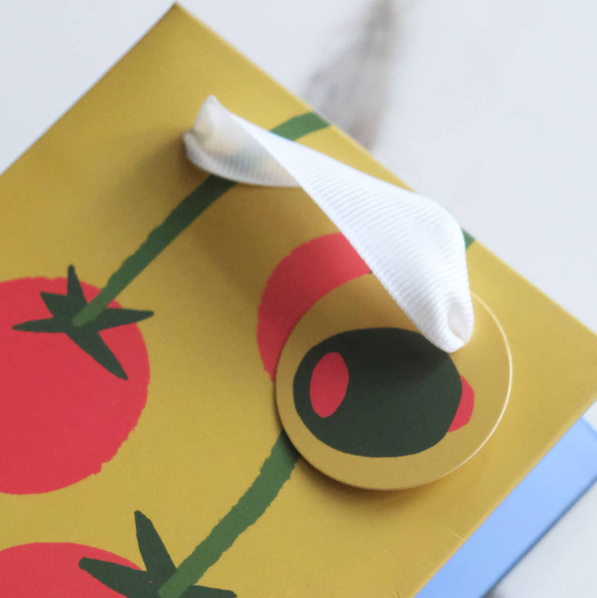 wine gift bag with a tomato illustration on a yellow background