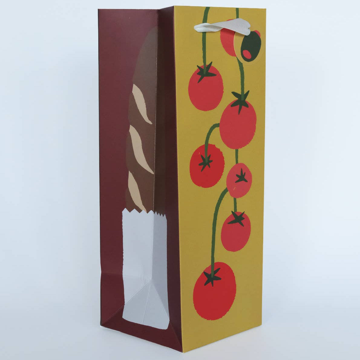 Product packaging with bread and tomato design on a white background