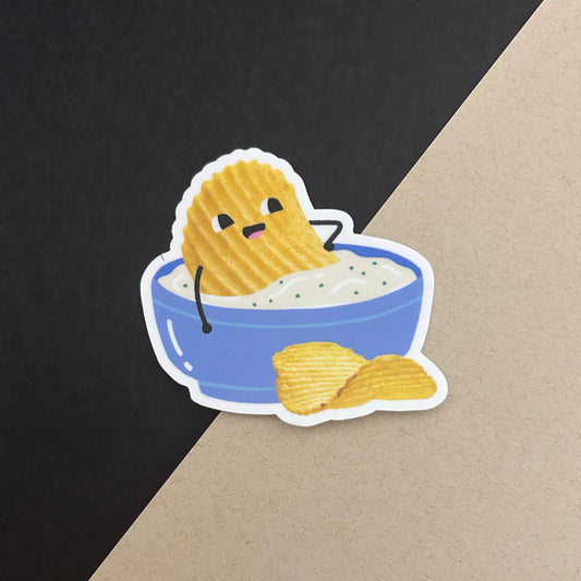 Cartoon potato chip character in a blue bowl filled with dip on a black and brown gradient background
