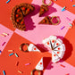 Cake earrings on a colorful background with sprinkles