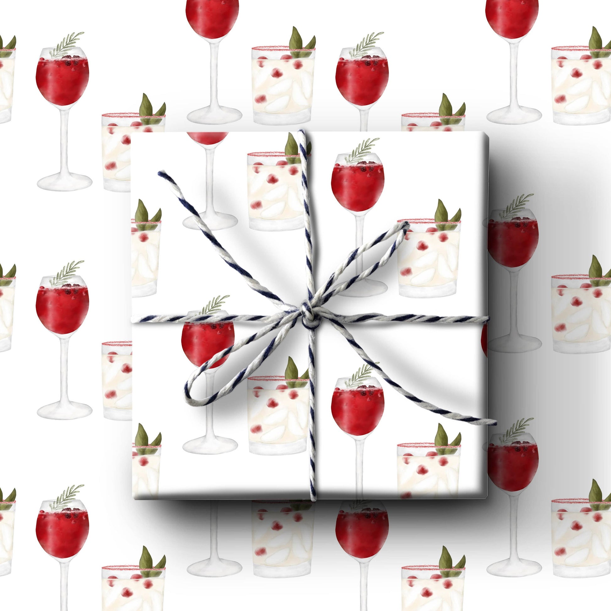 Christmas Cheer Wrapping Paper with patterns of holiday cranberry cocktails in rocks glasses with bay leaves and mulled wine.