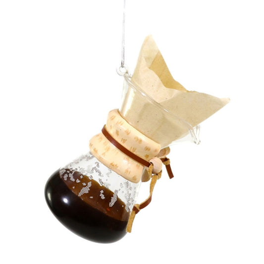 Coffee brewing apparatus with a glass carafe and paper filter on a white background