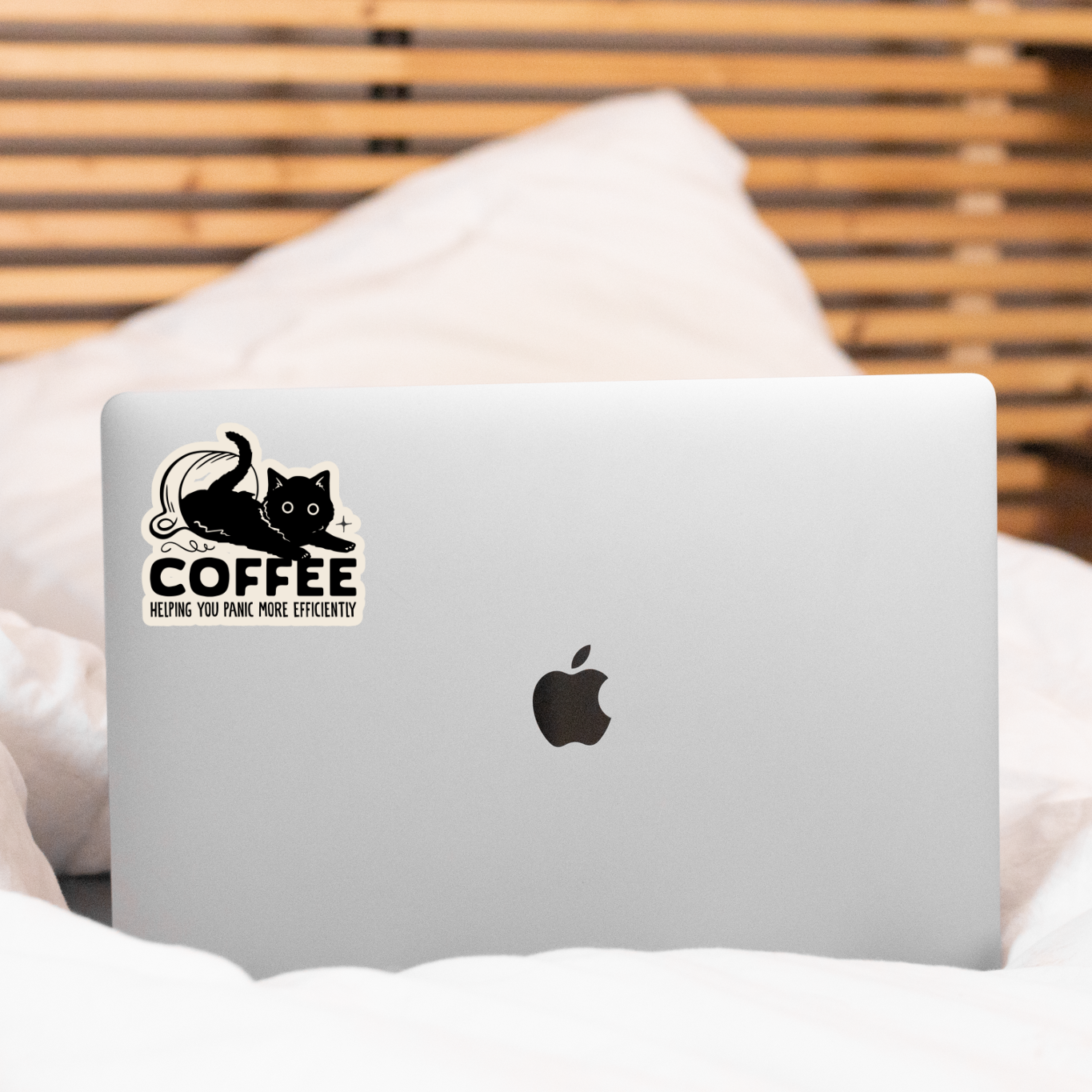 Laptop with a sticker on a bed