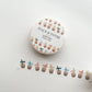 A roll of Peach & Paperie washi tape with a white label and a strip of the tape unrolled below, featuring a repeating pattern of boba tea cups in pastel colors on a white background.