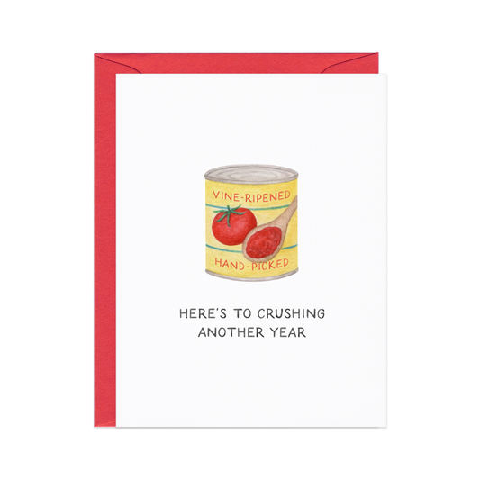 Card with a can of tomatoes illustration and text 'Here's to crushing another year' on a white background.