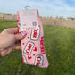 Pink product with 'Coke' branding held against a grassy outdoor background