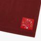 Cinnamon colored apron with mauve straps. This apron has a design that is dedicated to Dim Sum and has a steamer basket full of smiling dumplings and one dumpling being grabbed by chopsticks. This photo is the ampersand logo of Hedley and Bennet with an asian flair.