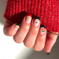 Set of decorative nail decals that look like Italian treats such rainbow cookies, pizzelles, espresso, panettone, and more. Show on a hand wearing French tips and a red sweater.