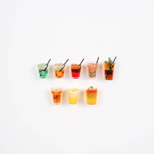 8 mini drink magnets lined up. All styles from iced tea, to boba to cocktails