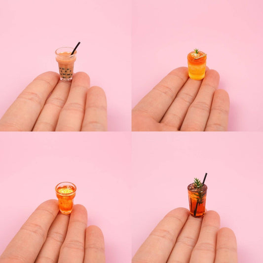 quadrant photo with a hand holding 4 different magnets. Boba, cocktail, iced tea and one with a rosemary garnish.