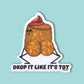 A die-cut sticker featuring a cartoon tater tot character with a red swirl on its head, sitting above the text 'DROP IT LIKE IT'S TOT' on a light aqua background.