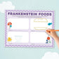A children's activity sheet titled 'FRANKENSTEIN FOODS' with illustrated food-themed boxes and lines, shown on a light blue background with a hand holding an orange pencil pointing at the sheet.