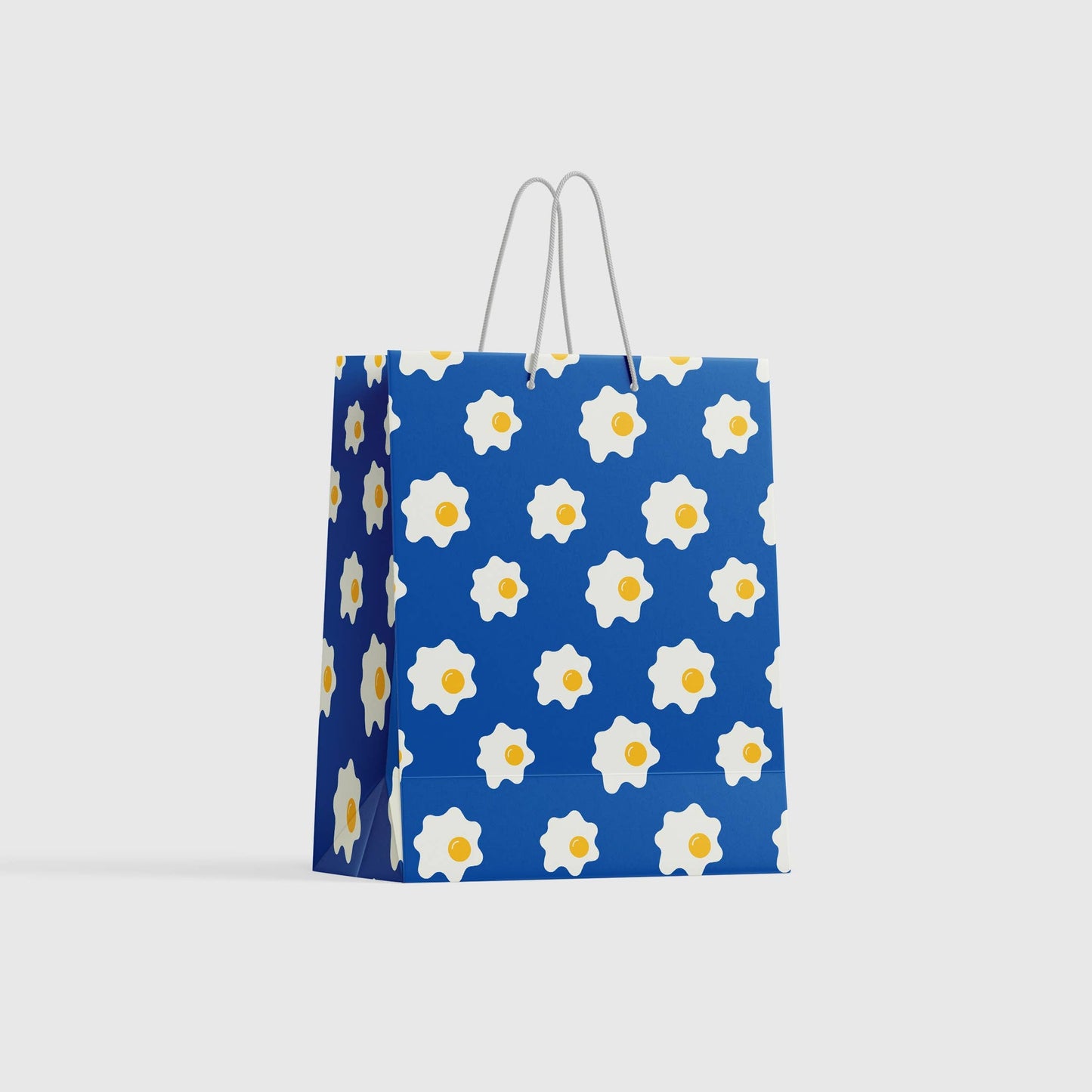 Gift Bag with blue background and sunny side up egg design on it 