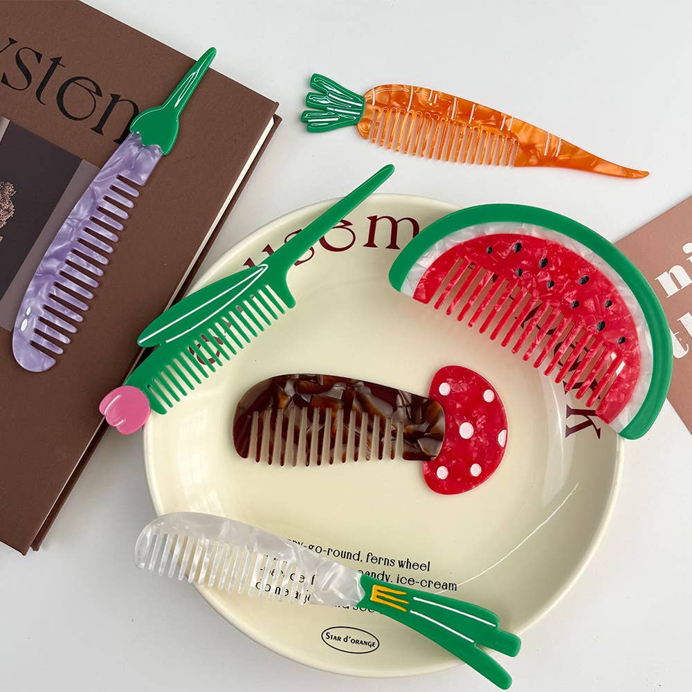Colorful combs shaped like fruits and vegetables on a white surface with books in the background.