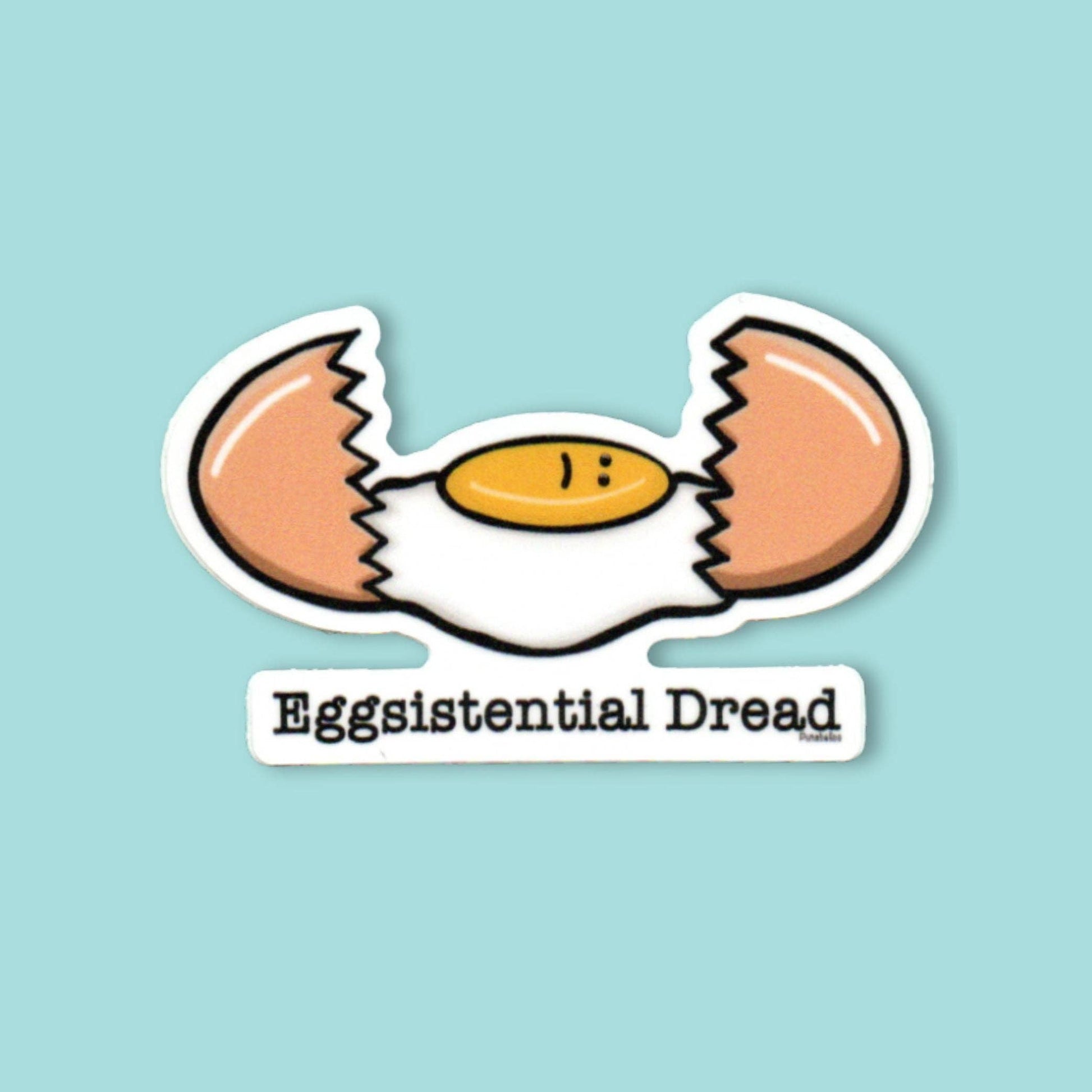 A die-cut sticker featuring a cartoon cracked egg with the text 'Eggsistential Dread' underneath, shown on a solid light blue background.