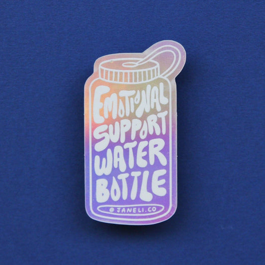 An iridescent enamel pin shaped like a water bottle with the text 'EMOTIONAL SUPPORT WATER BOTTLE' and '@JANELI CO' at the bottom, displayed on a solid blue background.