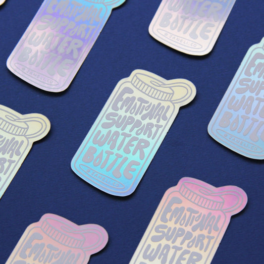 A repeating pattern of die-cut stickers shaped like a water bottle, featuring the text 'EMOTIONAL SUPPORT WATER BOTTLE' in a light gray font over an iridescent pastel gradient background. The stickers are arranged diagonally on a dark navy blue surface.