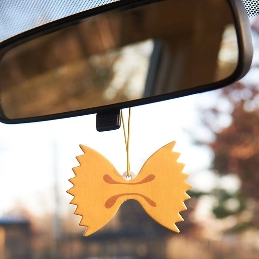 Car air freshener made to look like farfalle (bowtie) pasta hanging from rearview mirror 