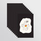 A stack of black post cards fanned out on a light gray background. The front card features a white irregular shape with a minimalist cartoon of ghost-like figures and the text 'IT'S CALLED FASHION, SWEETIE.'
