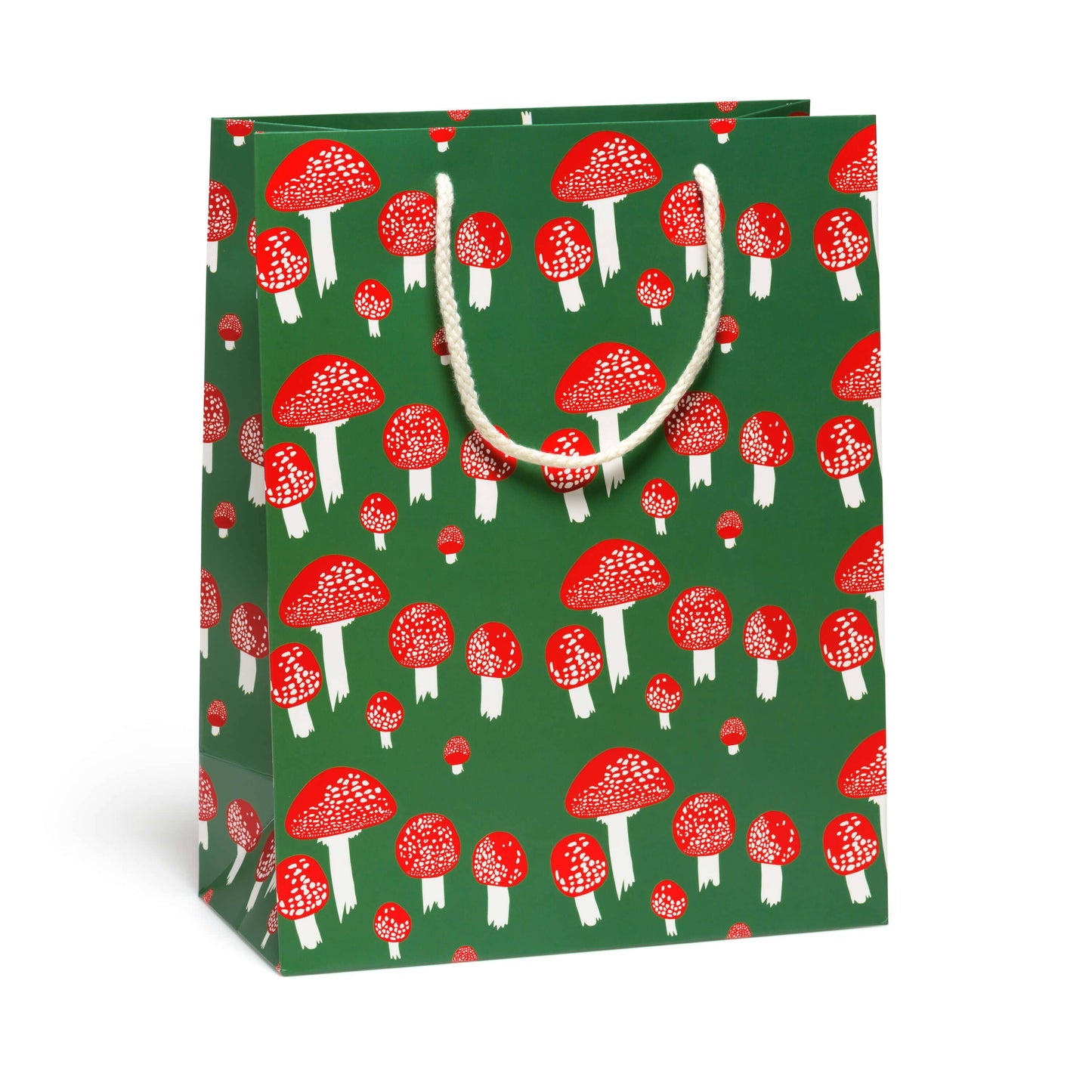 Forest green gift bag with whimsical mushroom design - red mushroom caps with white spots and white stems.