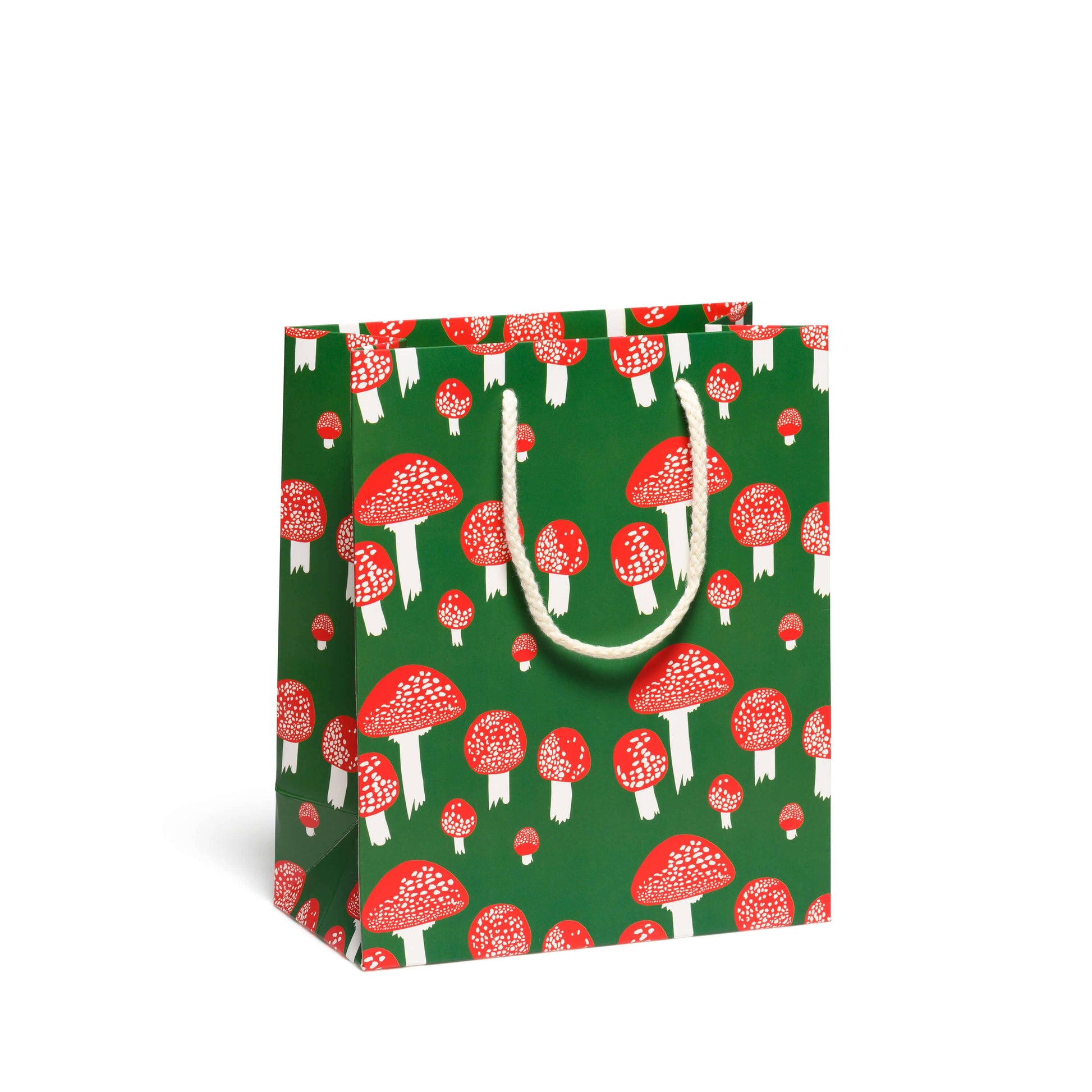 Forest green gift bag with whimsical mushroom design - red mushroom caps with white spots and white stems.