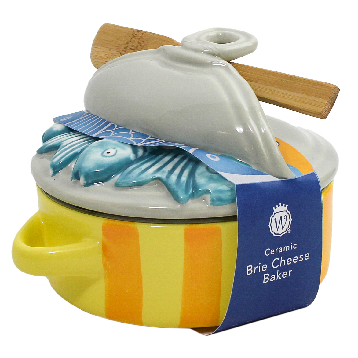 A ceramic brie cheese baker with a yellow and orange striped body, a white lid featuring a blue fish design, and a wooden spoon resting on top, wrapped in a blue paper band.