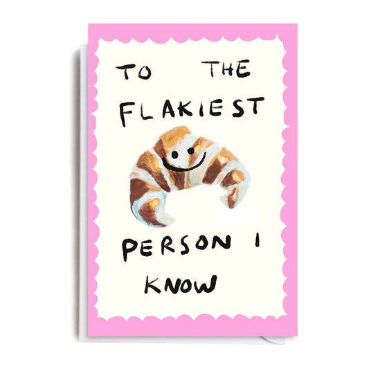 Greeting card with a picture of a smiling croissant, pink scalloped border, and text "To the Flakiest Person I Know."