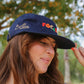 Focaccia Hat worn by a smiling model with long hair.