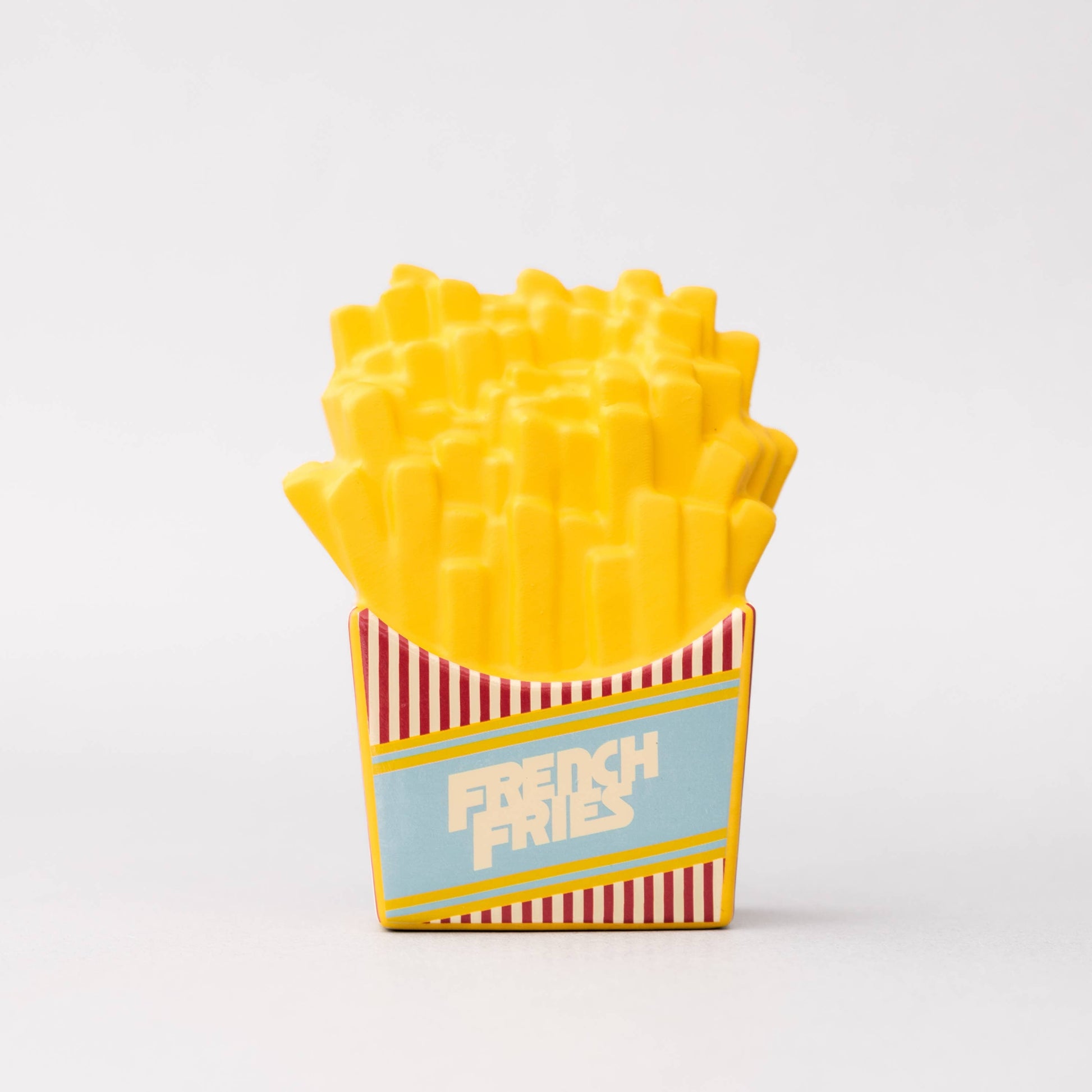 Toy French fries in a box with a striped design on a white background