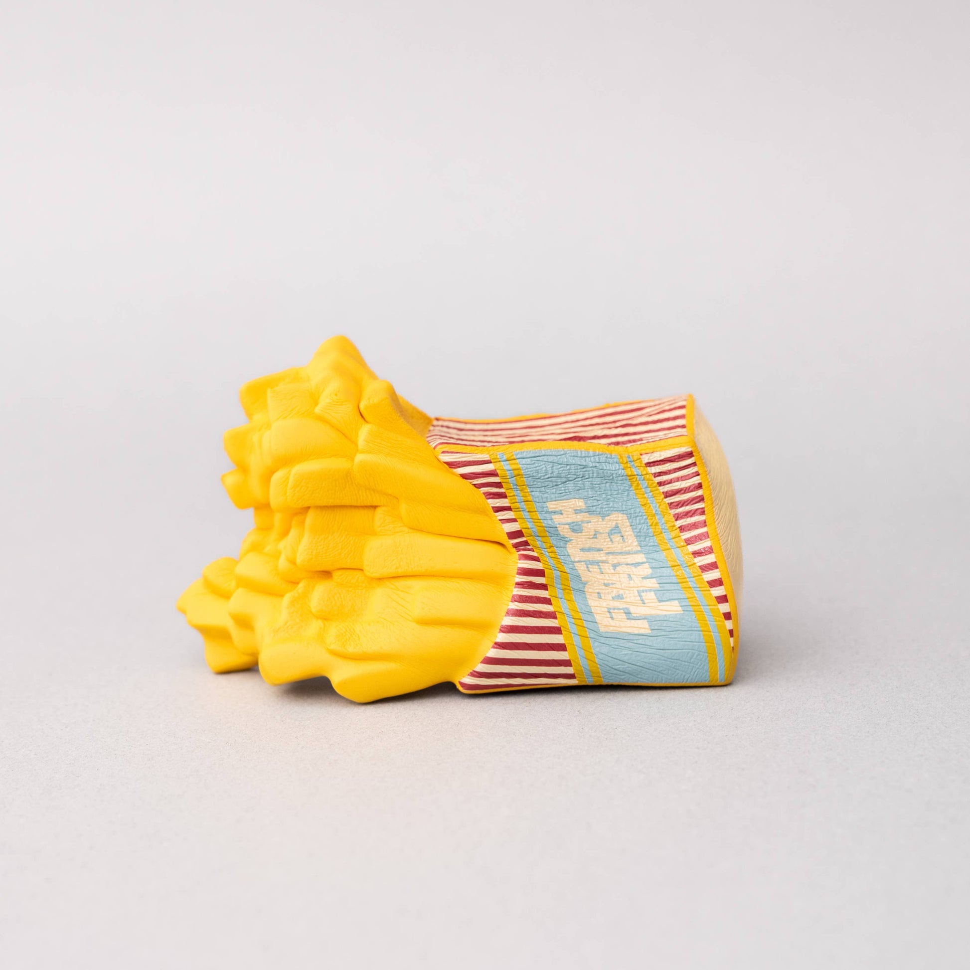 French Fry stress ball squished and laying on its side.