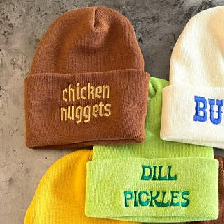 Chicken nuggets hat next to other hats