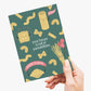 Hand holding a card with pasta illustrations and text on a white background