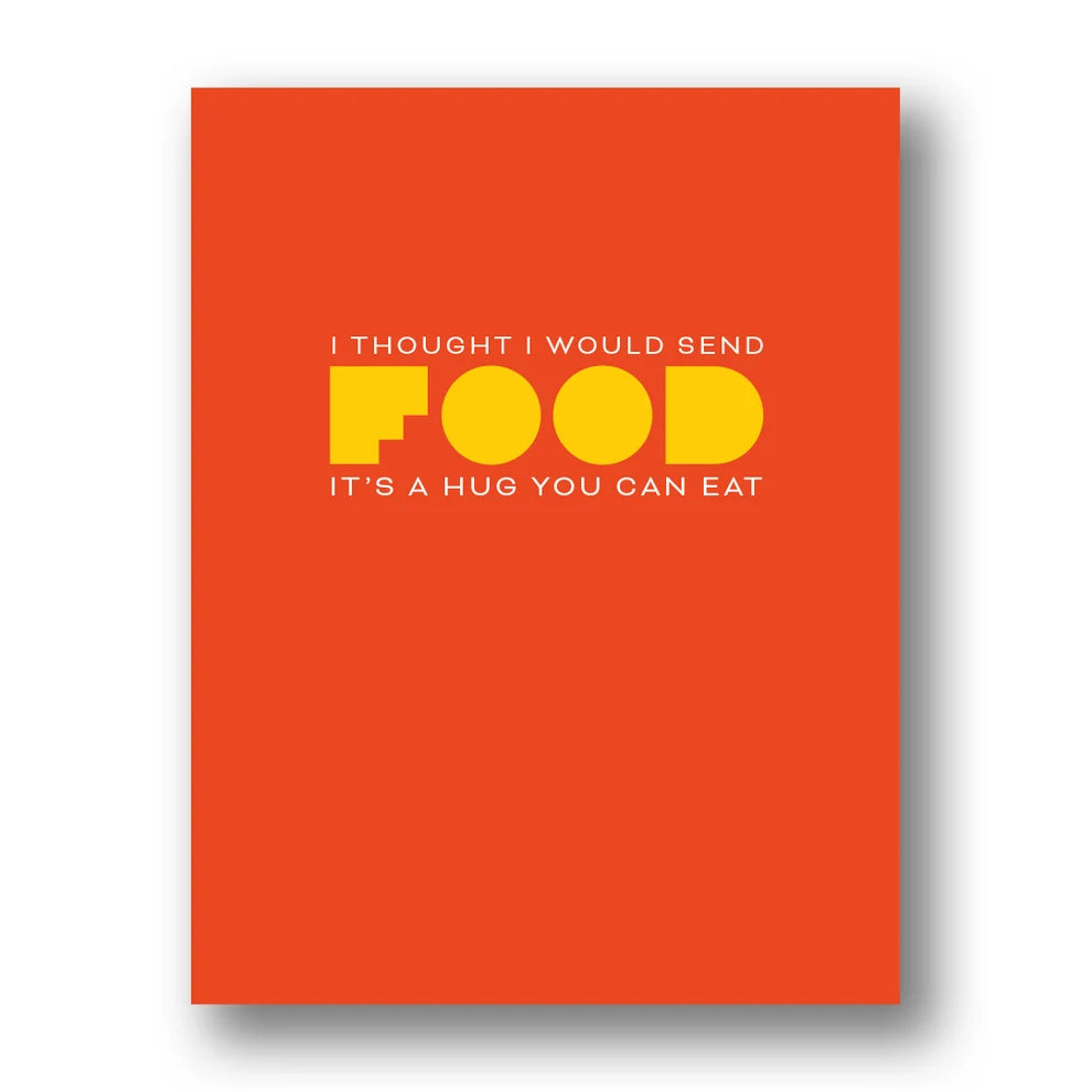 A rectangular orange greeting card with a humorous message printed on it: 'I THOUGHT I WOULD SEND FOOD IT'S A HUG YOU CAN EAT' in white and yellow text, shown against a white background with a soft drop shadow.