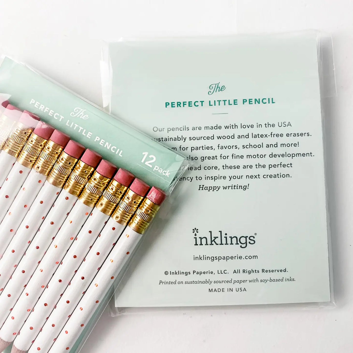 Front and back of white pencil pack. Front package shows white pencils with foil polka dots. Back wrapper gives a description of "The Perfect Little Pencil" and Inklings business information.