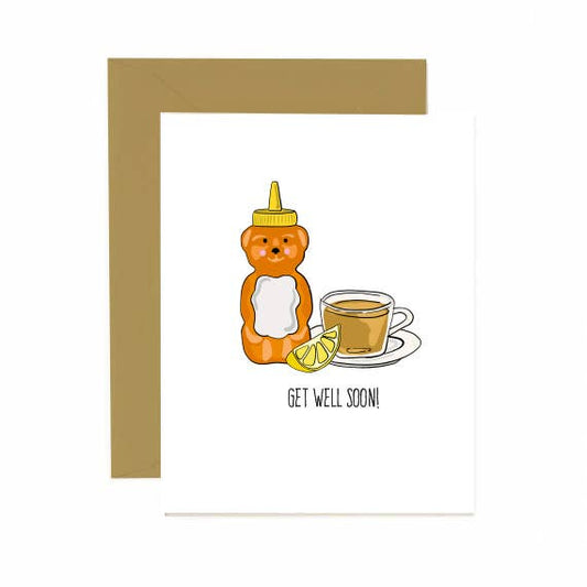 Honey bottle shaped like a bear, tea cup, and lemon wedge on a white background. Text "Get Well Soon!"