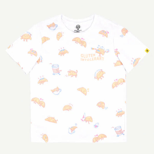 T-shirt featuring an all-over print of little croissant characters dealing with their tummy troubles in a variety of ways - soaking up sun on vacation, running around with a cup of coffee, hanging with friends, etc. Text on upper right corner reads "Gluten Intolerant"