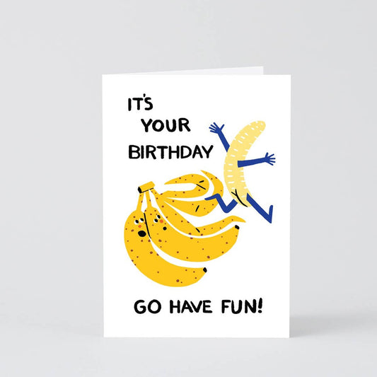 Birthday card that says "It's Your Birthday... Go Have Fun!" with an illustration of three bananas - one of the bananas has unpeeled itself and is running away from the bunch with his arms waving and little banana booty showing.