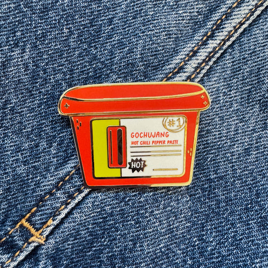 Enamel pin of korean Gochujang container on denim fabric