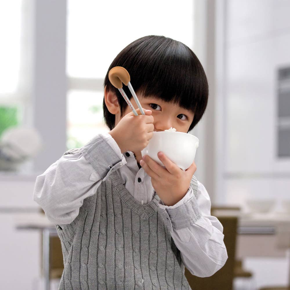 asian child eating a bowl of rice using the Good Fortune chopsticks