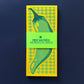 Notepad with green and yellow checkered design and 'Pier Six Press' branding on a dark blue background