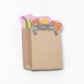 Stack of sticky notes with design of a cat inside a grocery bag 